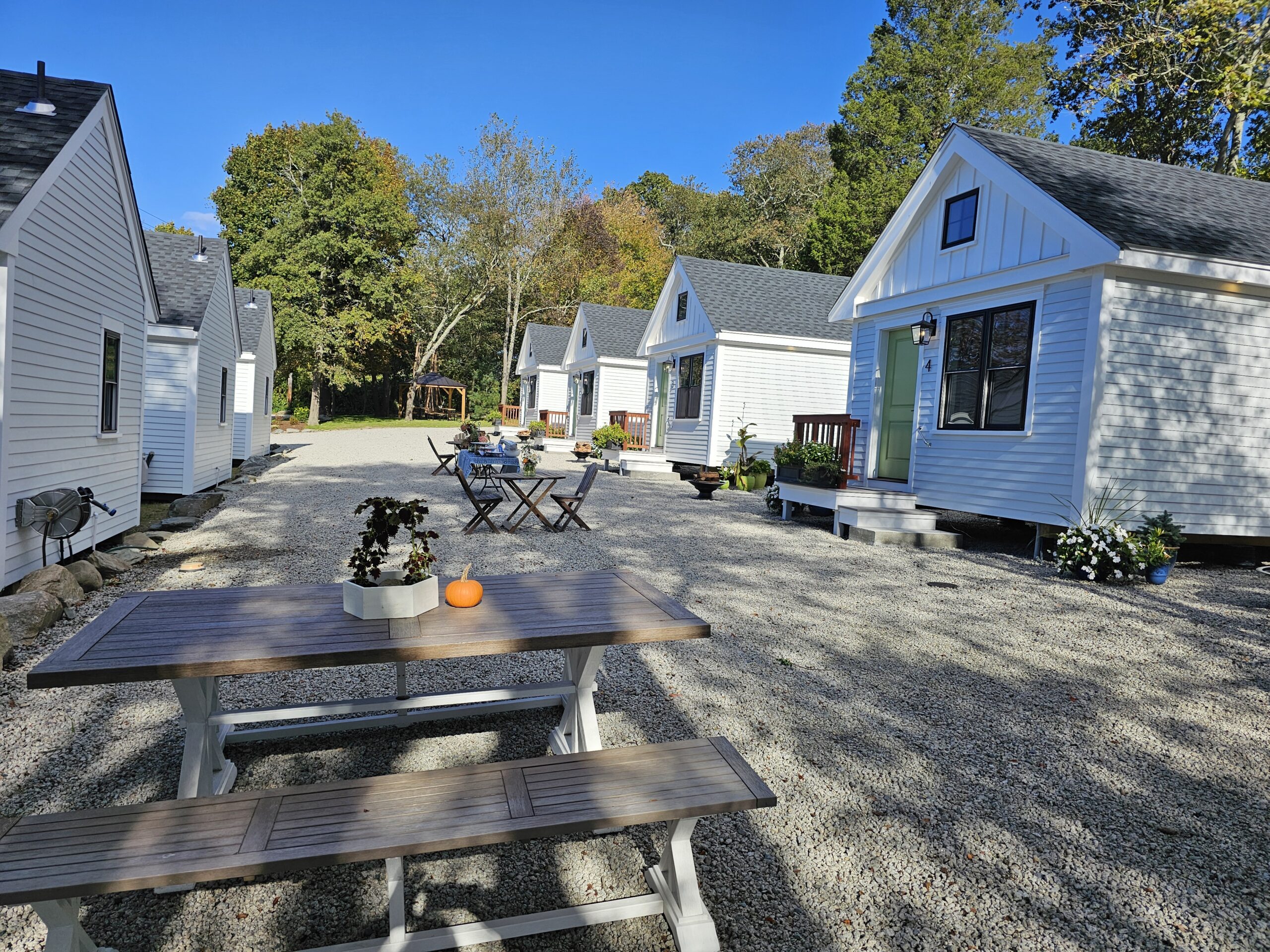 Finished cottage exterior gathering area with chairs and tables